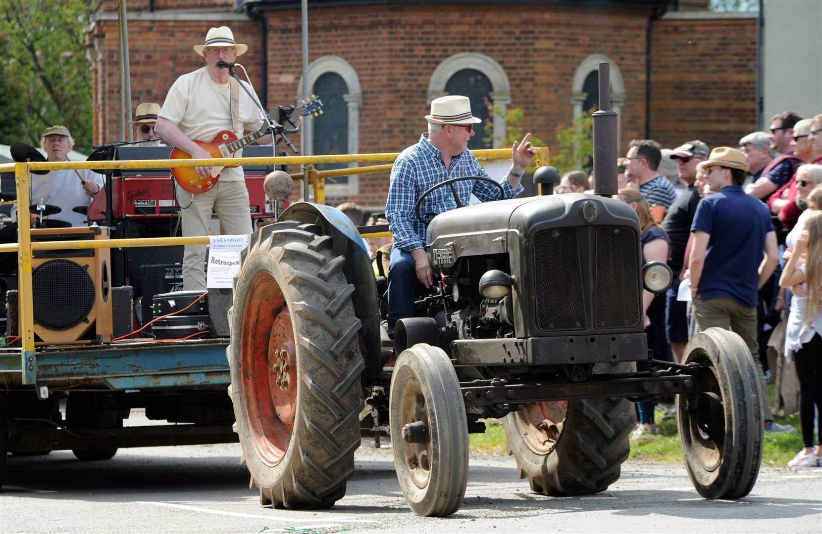 A tractor pulls the band along