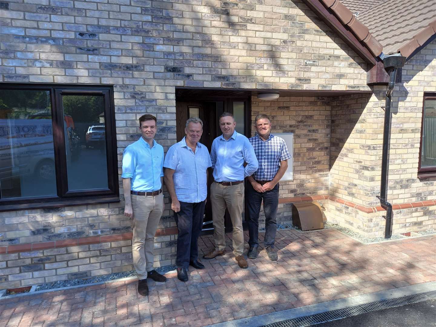 Leader of South Kesteven District Council Kelham Cooke, district councillor Robert Reid, architect Mike Daubney and Tony Hughes of D Brown Builders outside the new council homes in Trinity Road, Stamford