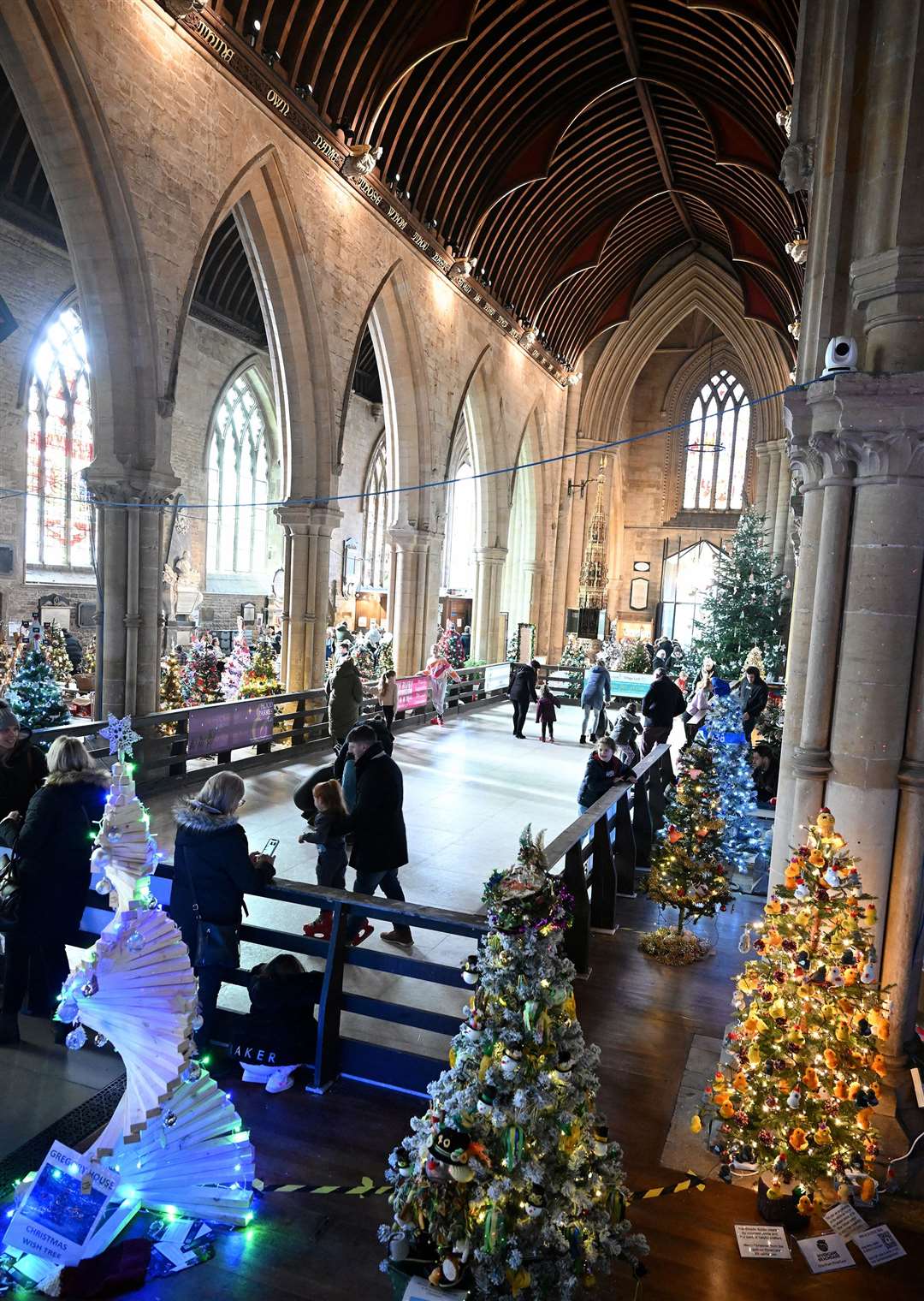 Visitors enjoying the St Wulfram's Christmas Tree Festival and skating rink.