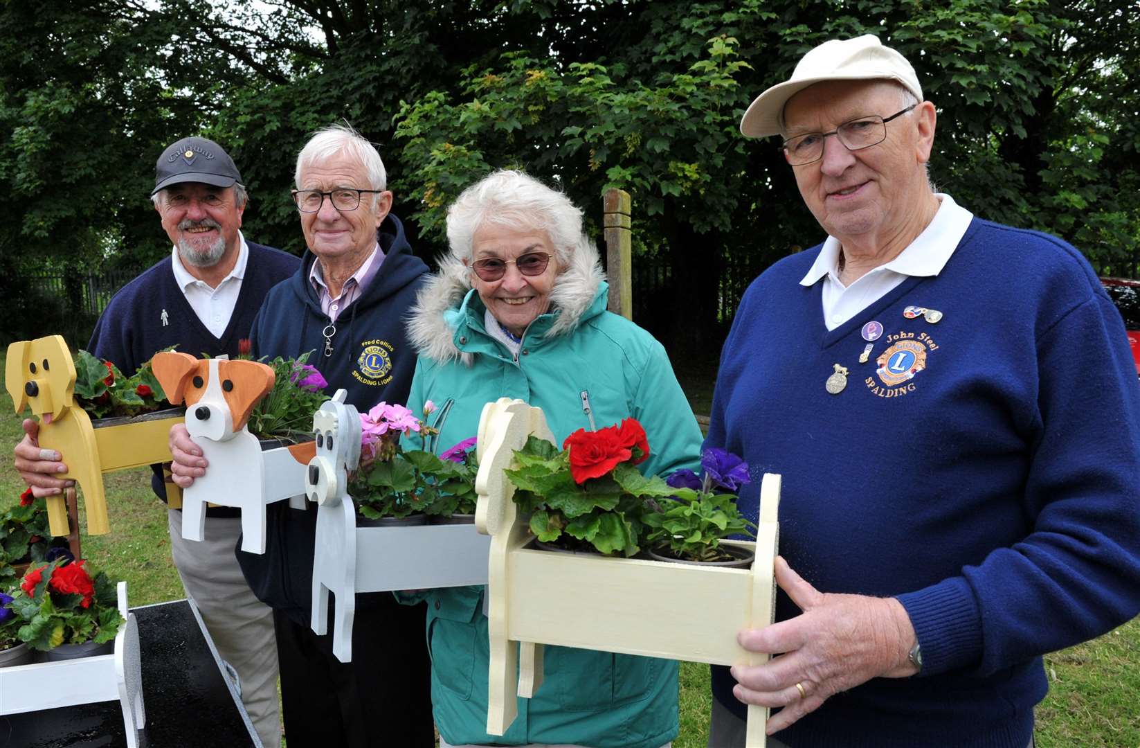 Spalding Lions Stuart East, Fred Collins, Margaret Collins, and John Steel with their dog flower displays