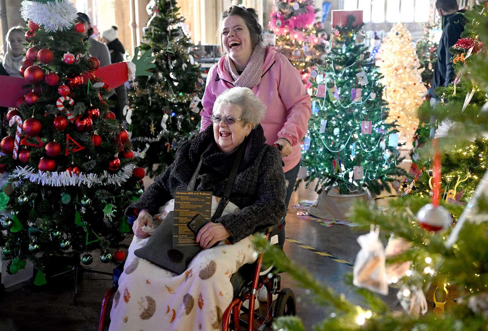 Visitors enjoying the St Wulfram's Christmas Tree Festival and skating rink.