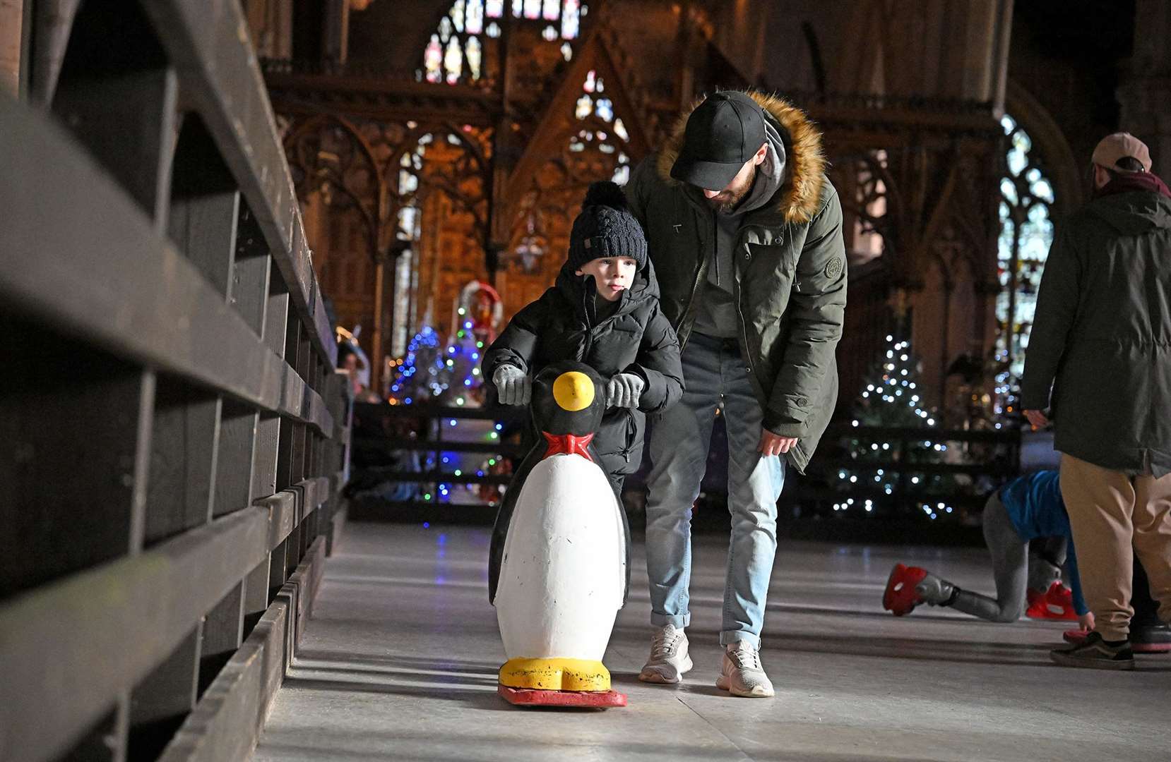 Visitors enjoying the St Wulfram's Christmas Tree Festival and skating rink.