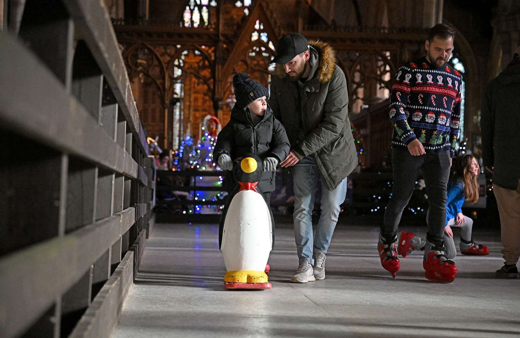 Visitors enjoying the St Wulfram's Christmas Tree Festival and skating rink.