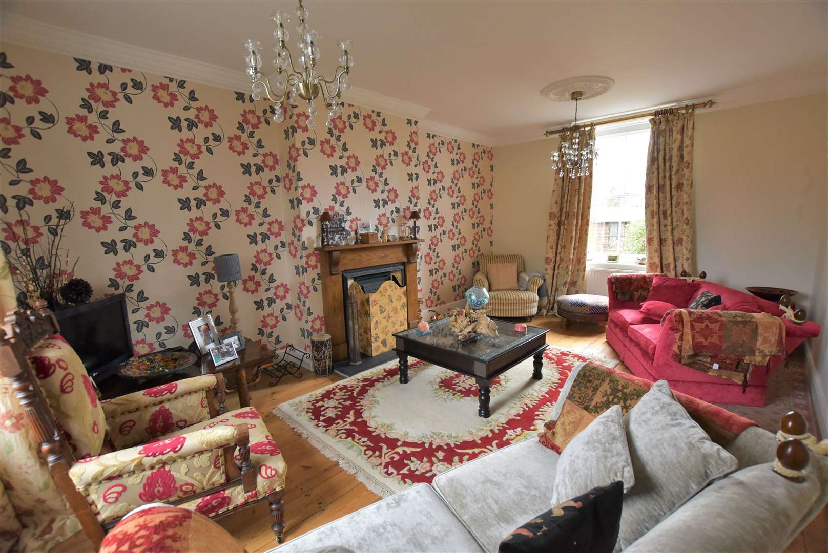 The spacious living room features a centralised gas fireplace