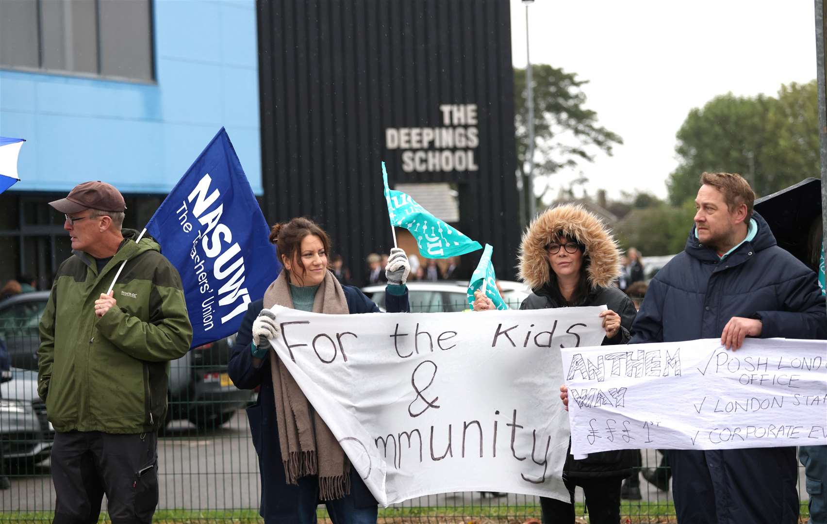 Staff wave banners to gather support. Photo: Paul Marriott