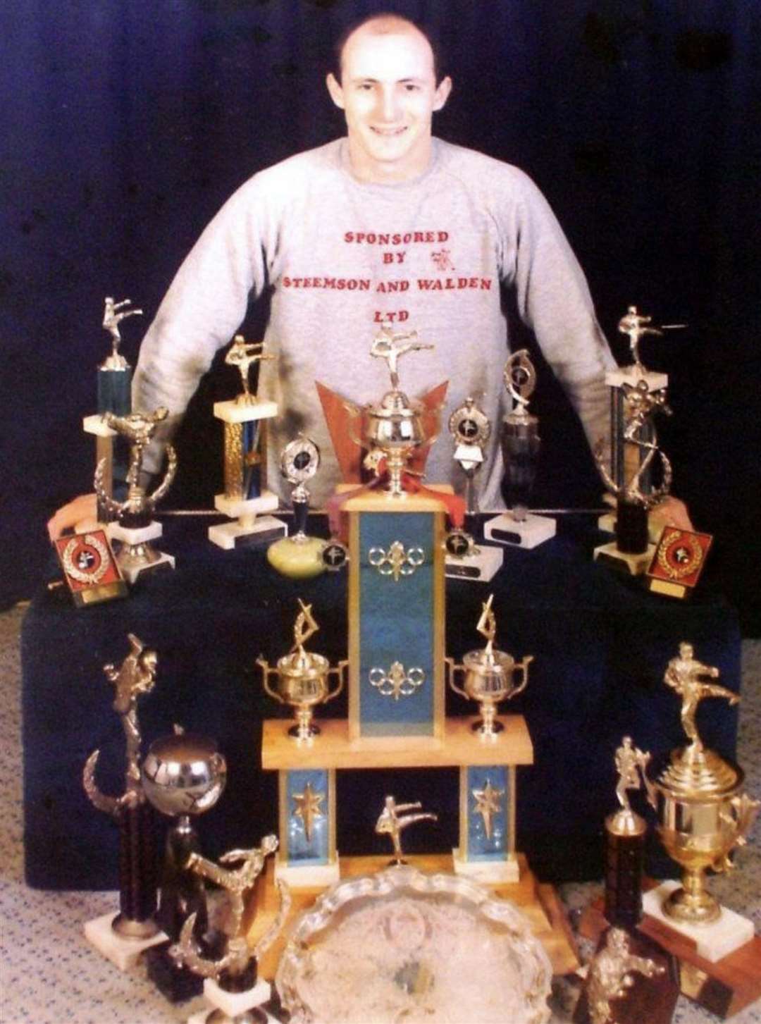 Dave Mears with his taekwondo trophies