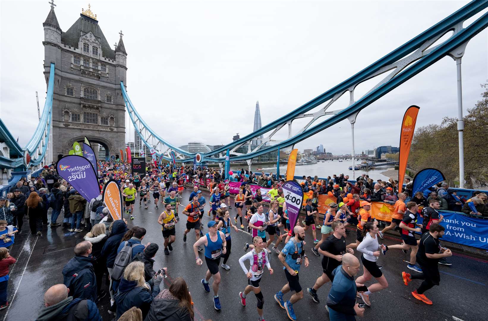 Participants cross Tower Bridge with the sub 4 hour pace runner during The TCS London Marathon on Sunday 23rd April 2023. Photo: Thomas Lovelock for London Marathon Events/TCS London Marathon