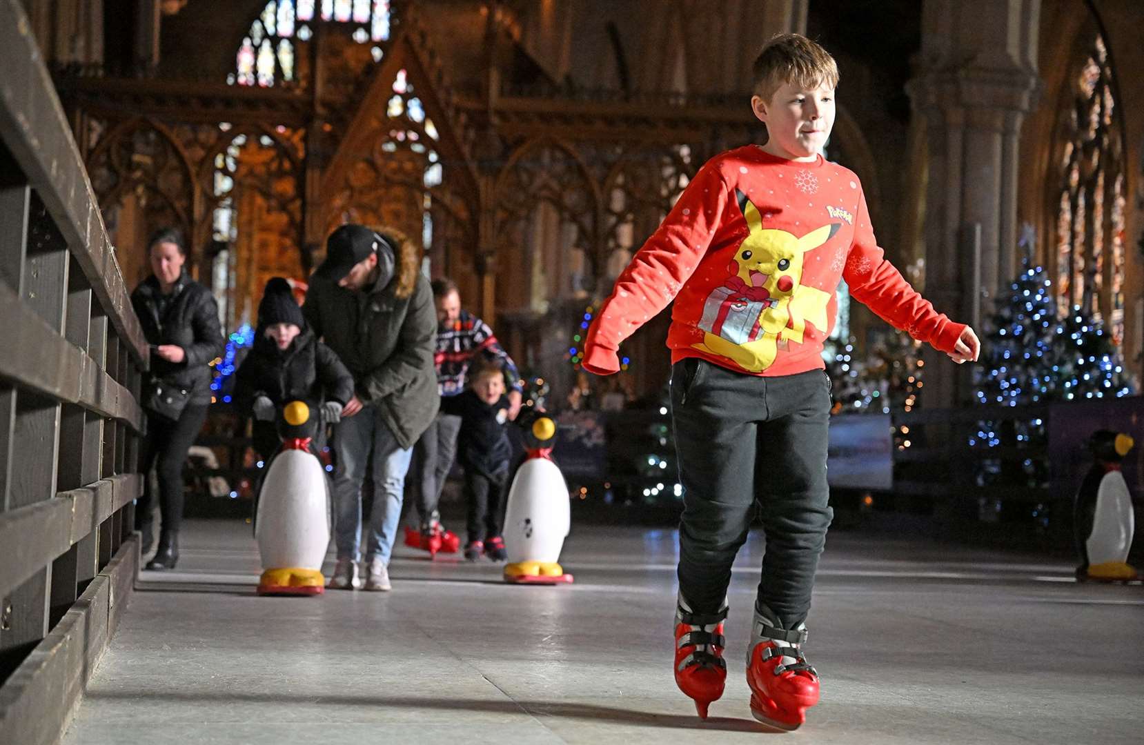 Visitors enjoying the St Wulfram's Christmas Tree Festival and skating rink.