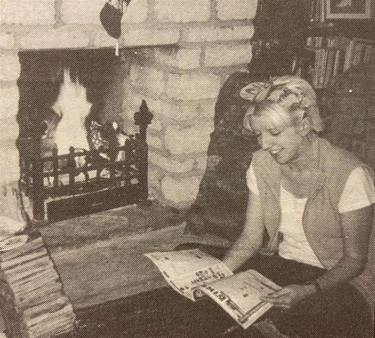 Tina Favell the Rockingham Forest Trust log lady warming up by a roaring Rockingham firewood blaze 25 years ago.