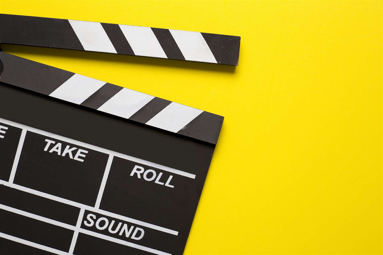 Movie clapper on yellow background. Photo: iStock/Tatomm
