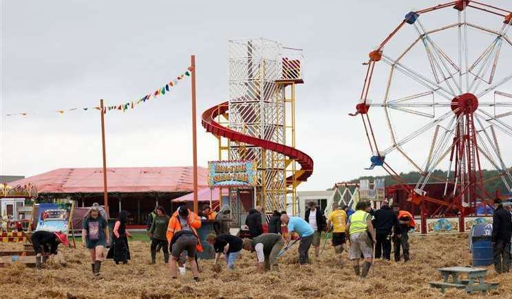 Last year's festival saw volunteers help spread straw when heavy rain affected the event