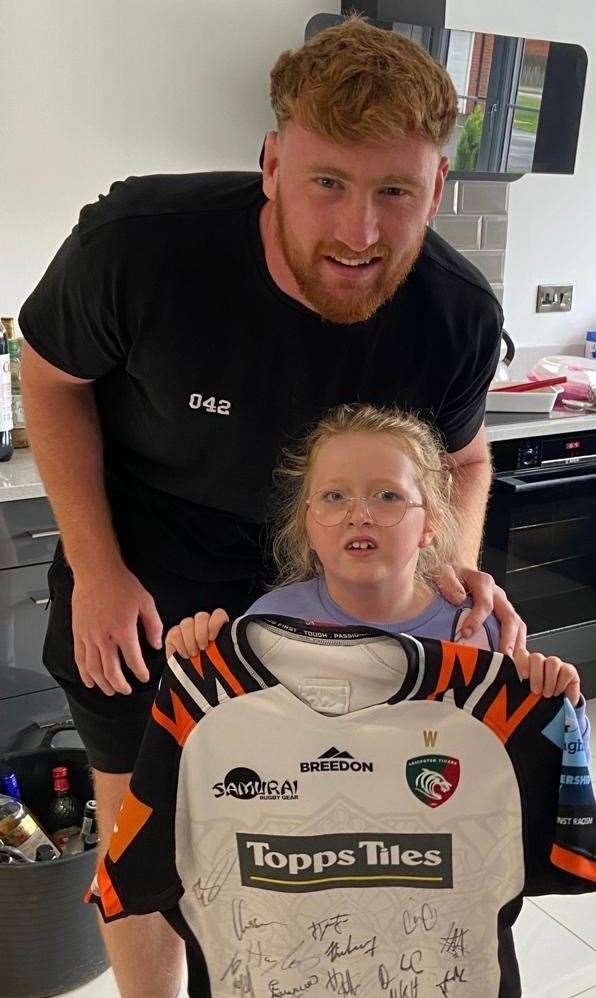 Freya Birch with Leicester's Ollie Chessum and a signed top which helped raise £350 for a previous fundraising event.