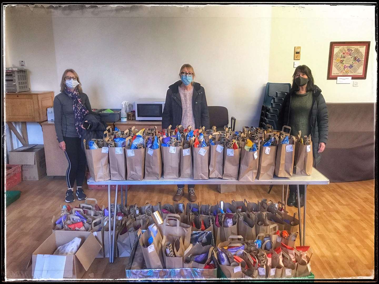 Volunteers with the presents and treat boxes at Second Helpings