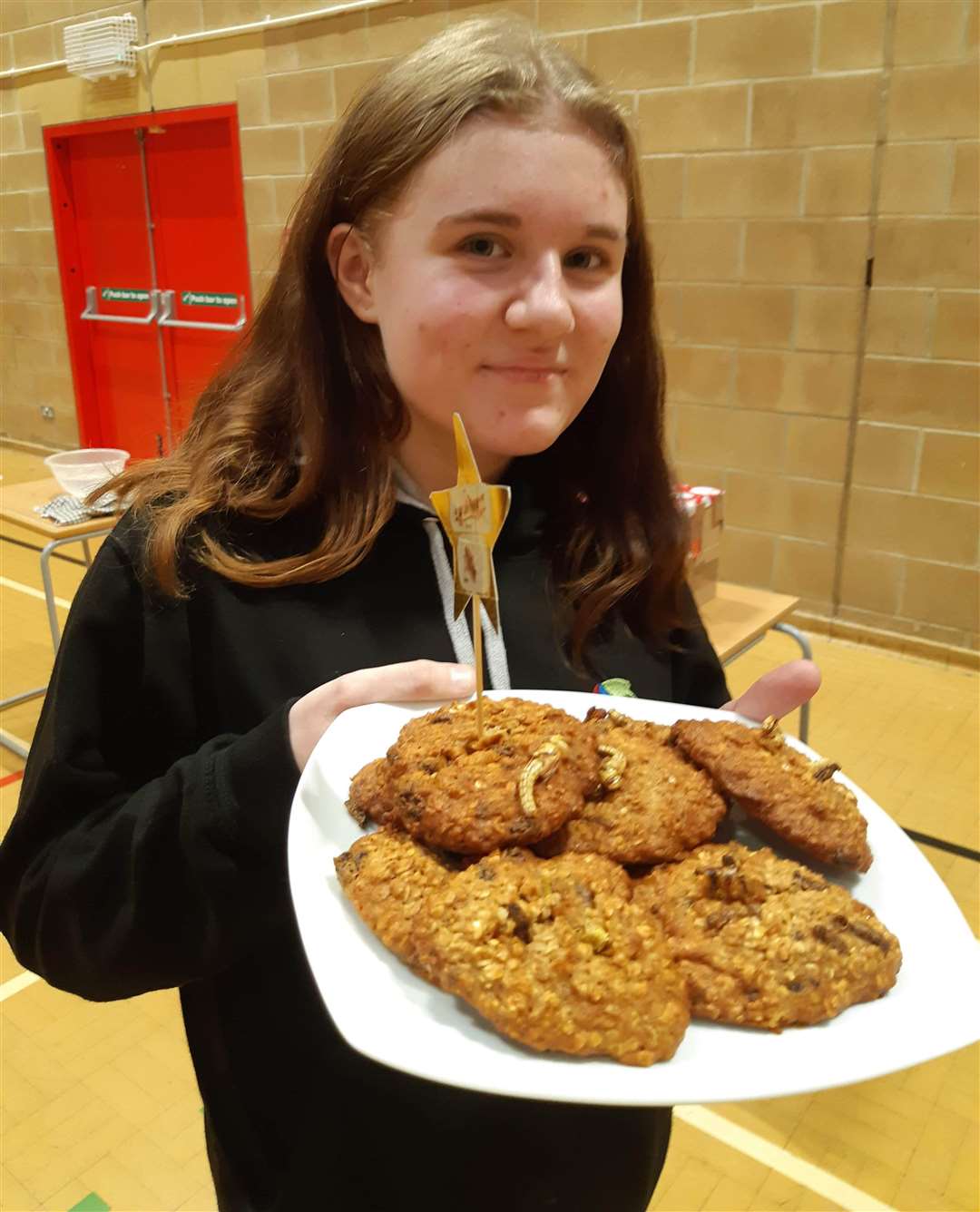 Laura Grainger holds a plate of bug biscuits