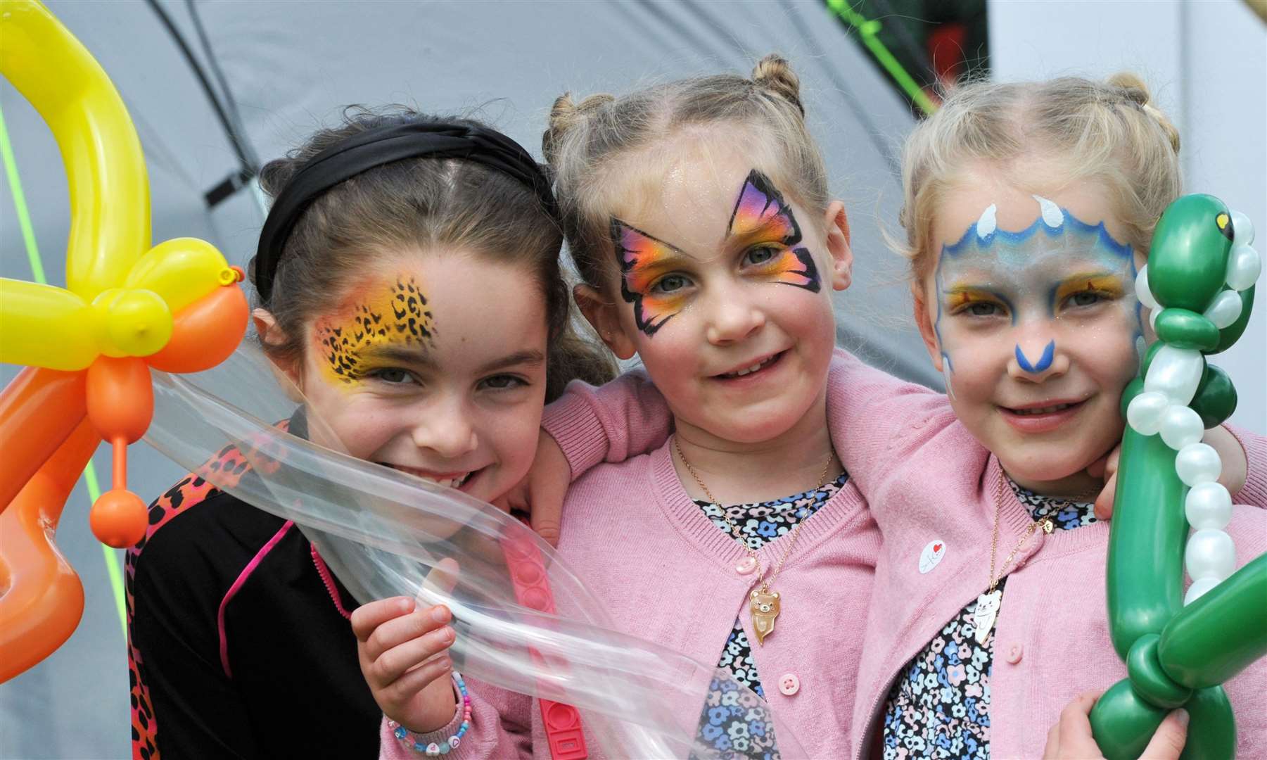 Sisters Rosie (7), Poppy (5) and Lilly (5) tried the face painting and balloon modelling. Photo: Iliffe Media