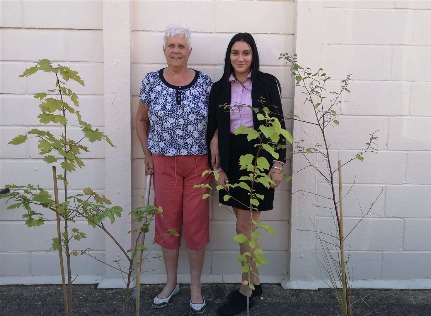 Coun Carol Rudkin and apprentice clerk Brandi Rogan with some of the trees planted in Hall Gate Cemetery, Holbeach. Photo supplied.