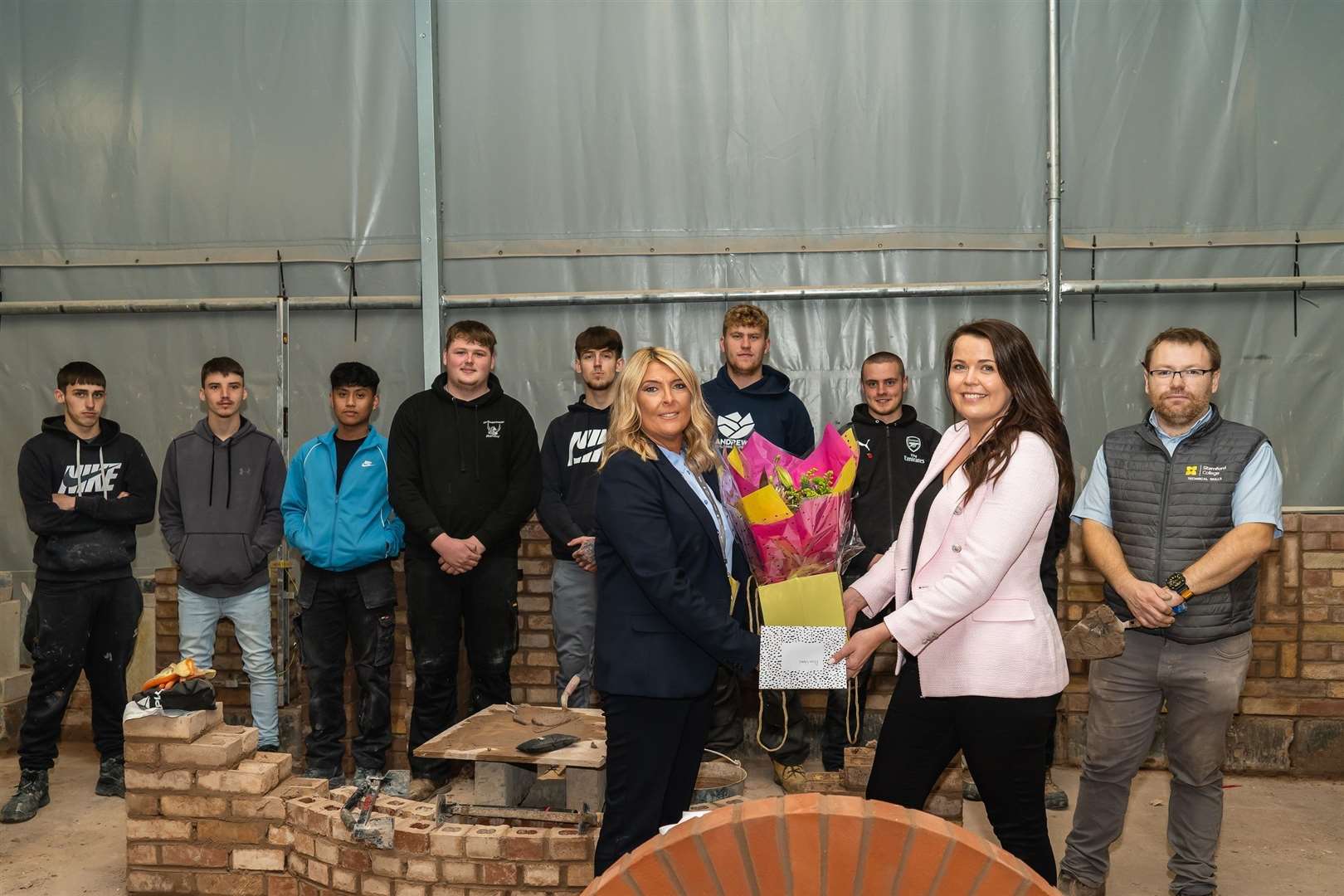 Allison Homes donates bricks to Stamford College. Pictured are Students of Stamford College, Emma Hill, Naomi Tickle and Tom Deignan, lecturer in brickwork