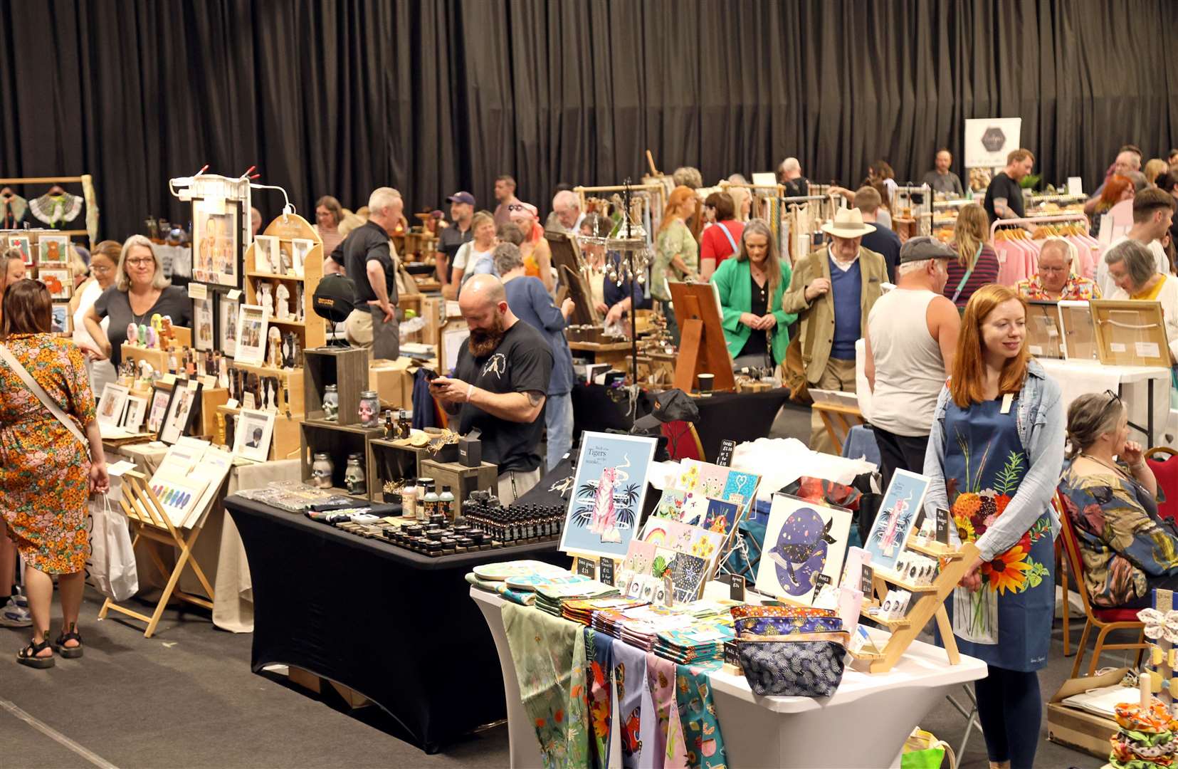 Shoppers browse stalls at the Summer Makers Market held at Springfields Event and Conference Centre, Spalding, Lincs., on 22nd June, 2024.