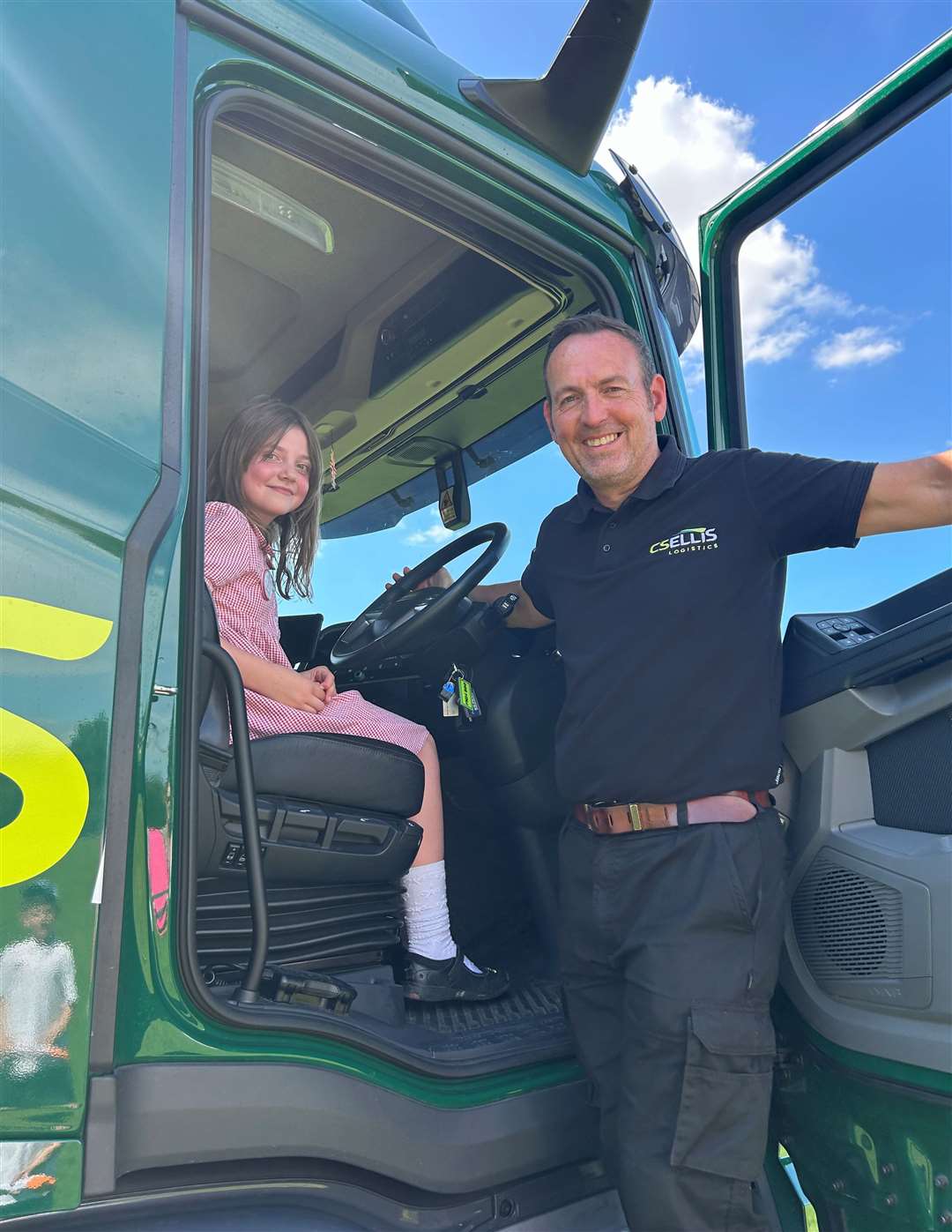 Steve Taylor shows Holly the inside of the cab on a C S Ellis lorry