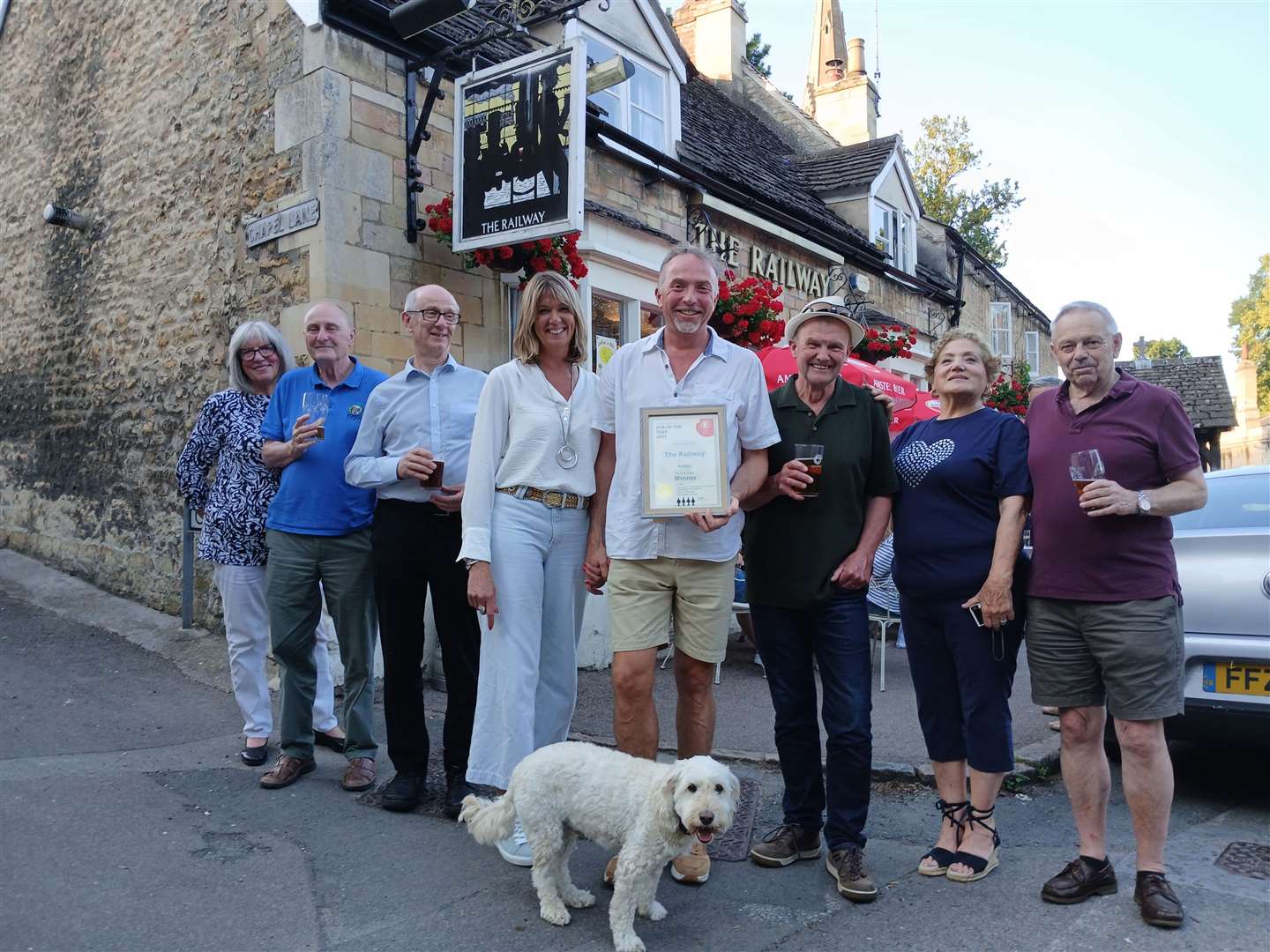 Landlords of The Railway Linda and Jamie Betts, centre, with Camra members and the pub's dog, Bowie